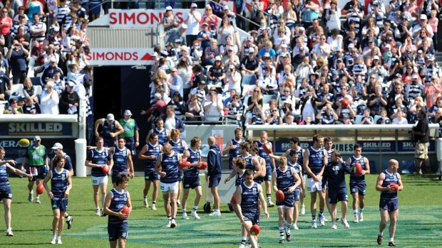 Geelong players make their way on to the ground in front of thousands of fans.
