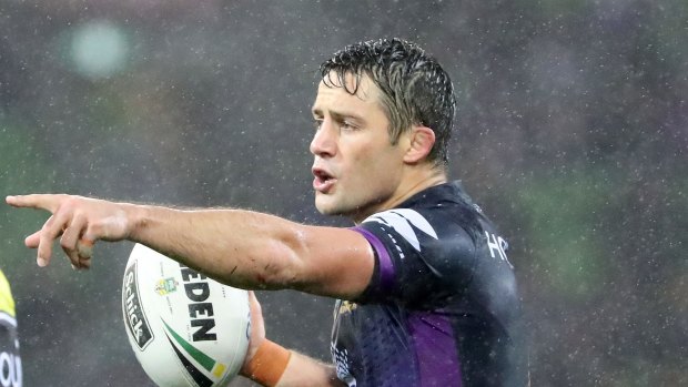 Keeping hold: Cooper Cronk on the ball for Storm during the downpour.