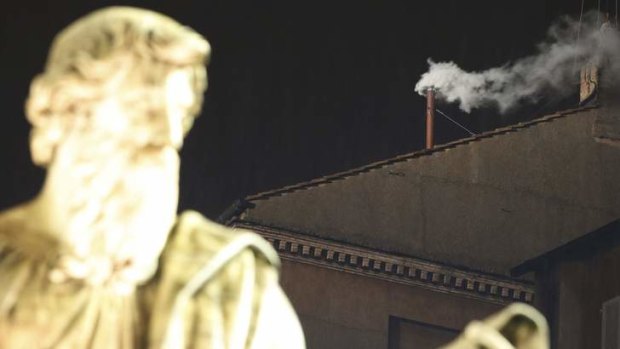 White smoke rises from the chimney above the Sistine Chapel in the Vatican.