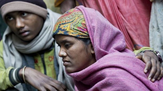 Devendra Kumar's widow, Suman, is consoled by her elder son Krishna at her house in the village of Barahpur,  120 kilometres north-east of New Delhi.