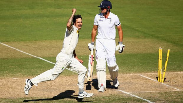 Prize scalp: Mitchell Johnson pumps his fist after dismissing Alastair Cook.