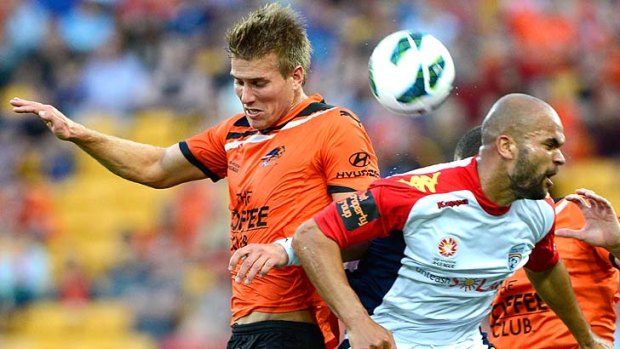 Erik Paartalu of the Roar and Serginho Van Dijk of Adelaide challenge for the ball during the round five A-League match between the Brisbane Roar and Adelaide United at Suncorp Stadium.