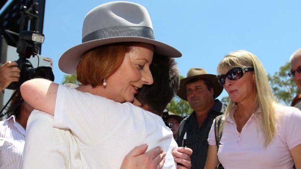 Memorial service &#8230; Julia Gillard comforts resident Dorelle Sunneth.