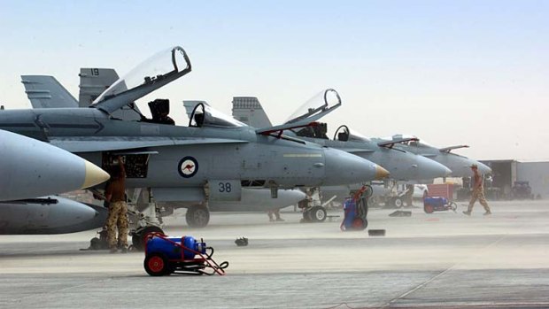 Dust storm: Ground crews battle to prepare the first Australian F/A-18 Hornet fighter jets to arrive in Iraq in February 2003.