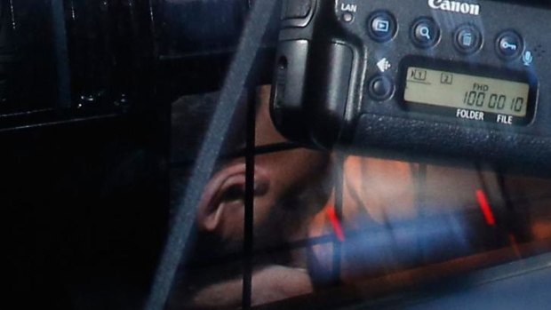 Omarjan Azari under police guard at Sydney's Central Local Court.