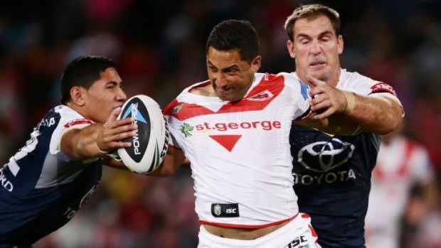Let me go: Dragons halfback Benji Marshall tries to break free of the North Queensland defence.