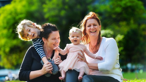 From left: Hamish Raftery (3) Amee Meredith, Zoe Raftery (4 months) and Kylie Raftery. Amee was a surrogate for Kylie's youngest child Zoe.