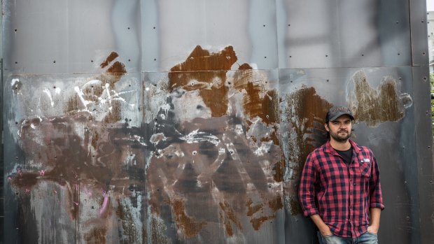 Roshan Nijar with some of the anti-hipster graffiti on his Footscray restaurant
