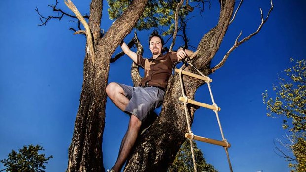 Natural high: Greg Foyster, one who has escaped the grip of a job addiction, indulges in some tree time at his home in Heidelberg.