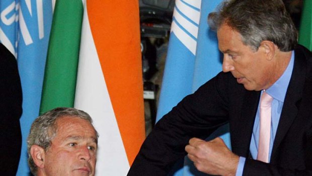 Casual .... George Bush Jr speaks to Tony Blair at the G8 summit in Russia.