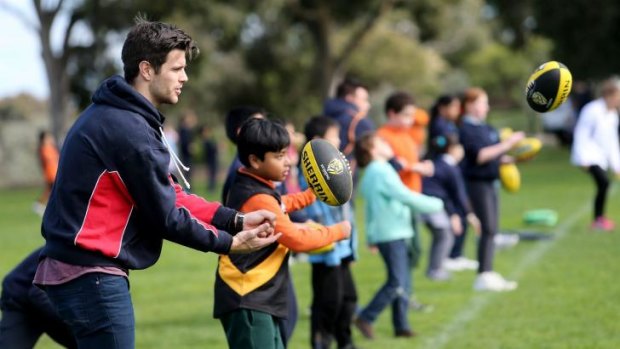 Richmond captain Trent Cotchin conducts a football clinic with children participating in the Australia Post Multicultural School Program.