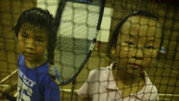 Playing ball ... Timothy Ham and Sophia Low get sweaty with a game of badminton at Dulwich Hill. The club has had to put on extra holiday classes to cope with demand from children wanting to learn the sport.
