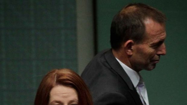 Attacking ... Julia Gillard and Tony Abbott .