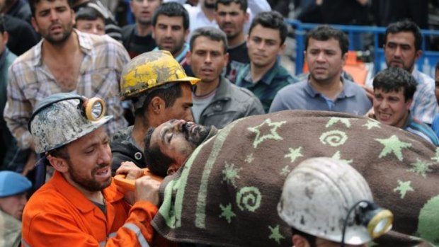 Mounting toll ... Rescue workers carry the body of a miner outside the coal mine in Soma, Turkey.