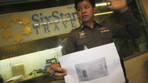 A Thai policeman shows a copy of Italian Luigi Maraldi'?s stolen passport.