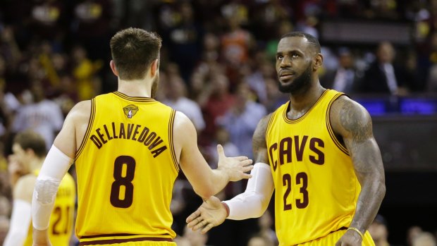 Cleveland Cavaliers forward LeBron James (23) celebrates with teammate Matthew Dellavedova during the second half of Game 3 of basketball's NBA Finals against the Golden State Warriors in Cleveland, Tuesday, June 9, 2015. (AP Photo/Tony Dejak)