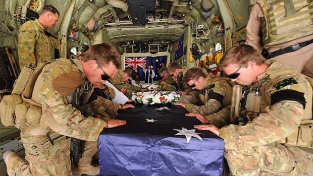 Goodbye &#8230; soldiers pay their last respects to Captain Bryce Duffy, Corporal Ashley Birt and Lance-Corporal Luke Gavin at a memorial service at Tarin Kowt before they are brought home. <em>Photos: Department of Defence</em>