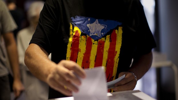 Turning point for Spain: A man votes at a polling station in Barcelona on Sunday. 