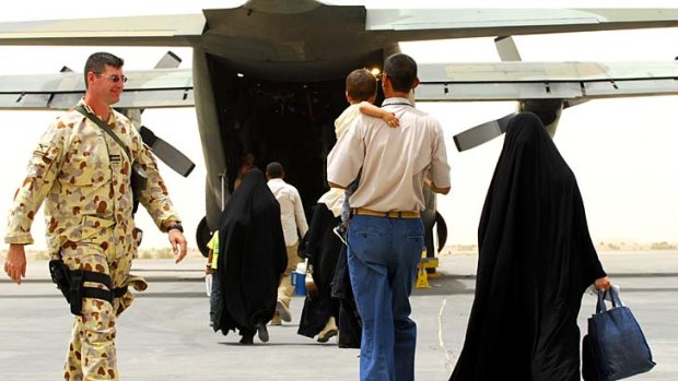 Iraqi interpreters and their families board a Hercules aircraft in 2008 on the first leg of the journey to Australia.