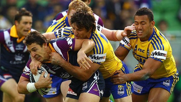 Signed a new deal ... Billy Slater is tackled by Nathan Hindmarsh.