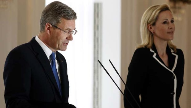 German President Christian Wulff announces his resignation. At right is his wife,  Bettina Wulff.