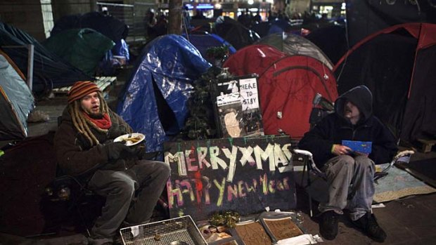 Occupy London Stock Exchange protestors eat dinner on Christmas eve in front of St Pauls Cathedral.