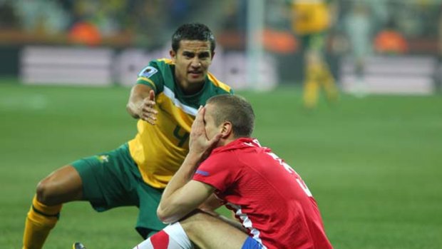Tim Cahill gestures towards Manchester United defender Nemanja Vidic in the match against Serbia.