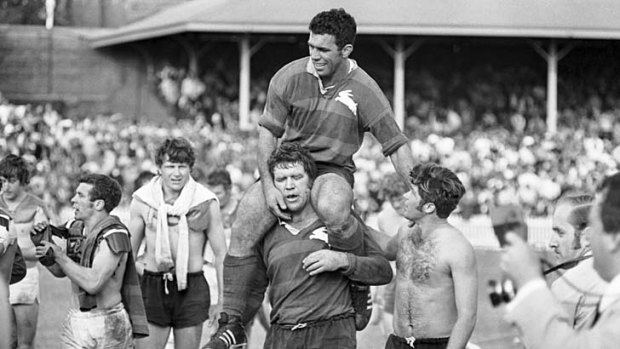 Victory ... captain John Sattler, suffering a broken jaw, is carried off by Bob McCarthy and teammates after Souths beat Manly in the 1970 grand final.