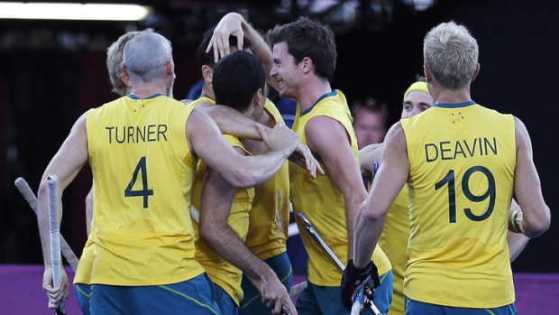 Quick out of the blocks ... The Kookaburras congratulate Mark Knowles after his  40th-minute goal put them 3-0 up against the hosts.