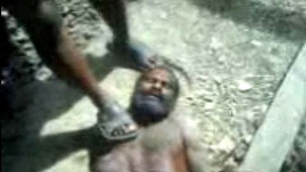 An image from the video of Tunaliwor Kiwo being tortured by Indonesian soldiers.