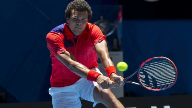 Jo-Wilfried Tsonga of France hits a return against Daniel Munoz-De La Nava of Spain during their eleventh session men's singles match on day seven of the Hopman Cup in Perth.
