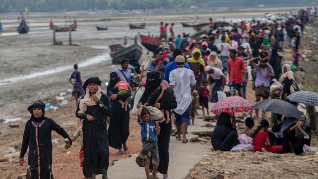 Rohingya Muslims, who crossed over from Myanmar into Bangladesh, walk towards the nearest refugee camp at Teknaf in September.