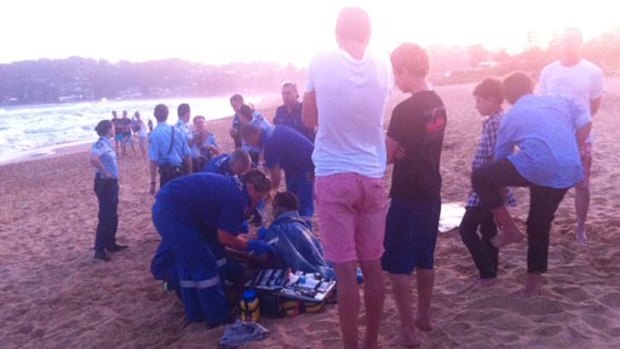 Shark attack ... paramedics treat the man.