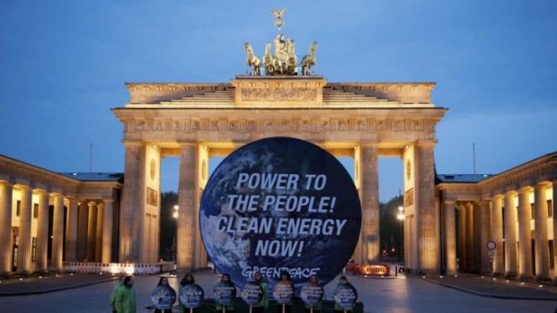 Members of Greenpeace in front of the Brandenburg Gate in Berlin, where the summary of the IPCC's report was released.