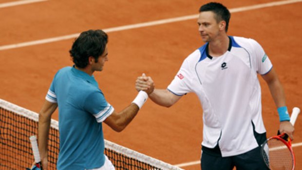 Robin Soderling (right) shakes the hand of world number one Roger Federer after knocking him out of the French Open.