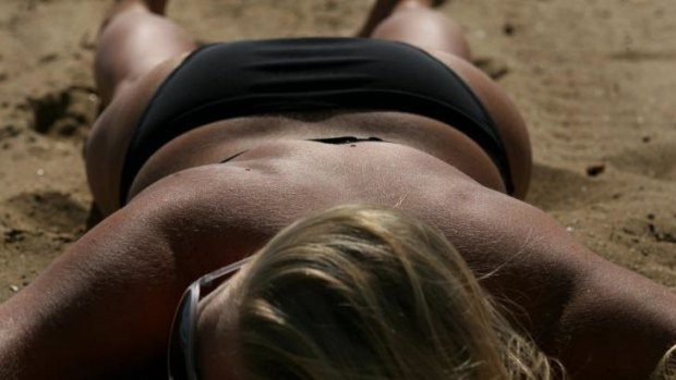 A sunbather at St. Kilda beach.