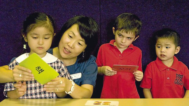 Another way to say it...Campsie Public students, from left, Amelia Rustamsir, Cade Humphries Jones and Luc Bui last week with teacher Eun Young Yoo, who will teach Korean as part of the bilingual language program.