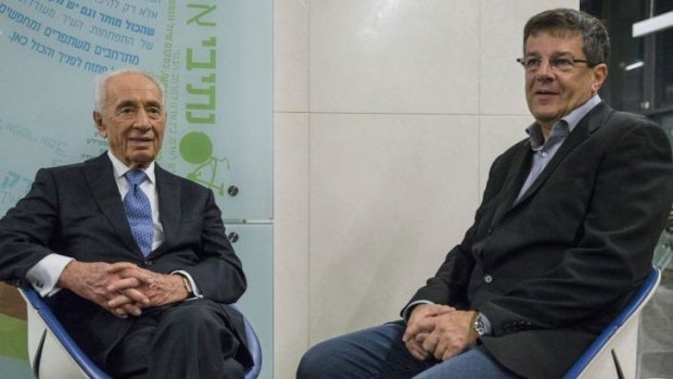 'Time is against us': Nobel laureate and former president Shimon Peres (left) speaks with Yuval Rabin, son of slain Israeli prime minister Yitzhak Rabin, at a rally to mark the anniversary of Rabin's assassination.