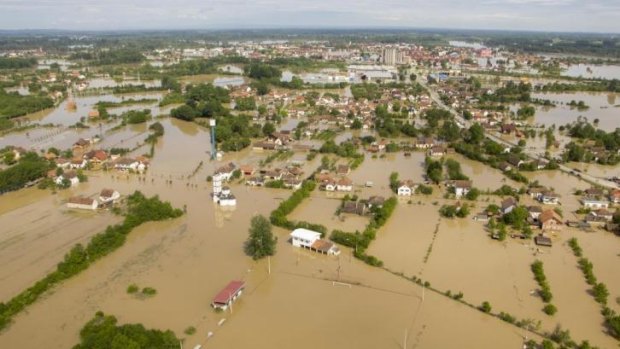 This photo made available by the Slovenian Police shows an aerial view of a flooded area near the Bosnian town of Bosanski Samac.