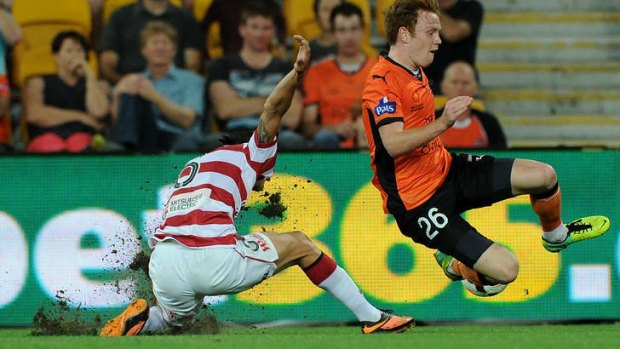 Corey Brown of the Roar is tackled by  Jerome Polenz of the Wanderers.