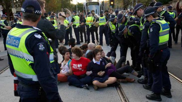 Teenage students sat on tram tracks on Spring Street during the heated protest.