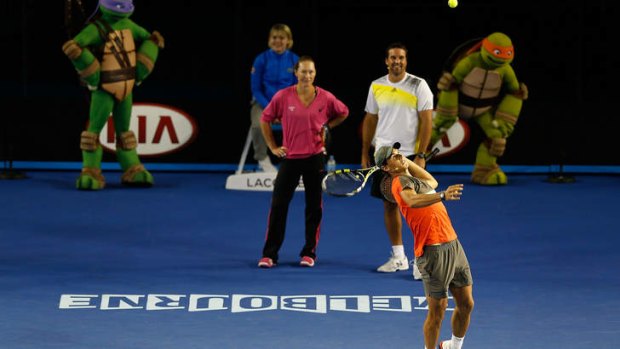 Child's play: Sam Stosur and Pat Rafter watch Rafael Nadal serve at Melbourne Park.