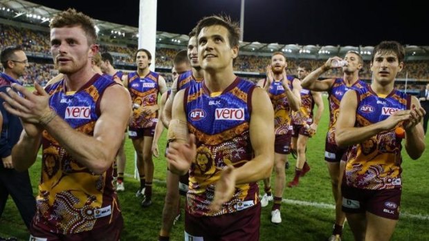 Pearce Hanley, Jed Adcock and Sam Mayes of the Lions celebrate after the game.