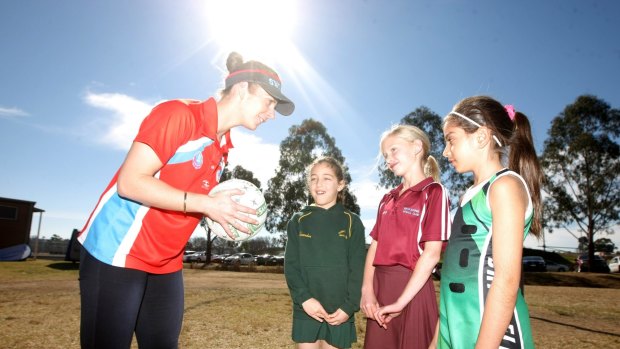 Balancing act: Alexandra Southern, Courtney Farrow, and Dayne Alahmad with Swifts player Abbey McCulloch. 