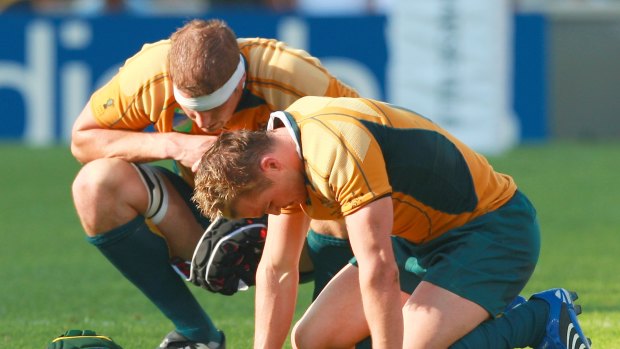 Down and out: Matt Giteau  (right) and Dan Vickerman show their despair after the Wallabies lost their World Cup quarter-final against England in 2007.