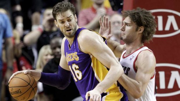 Los Angeles Lakers centre Pau Gasol backs in on Portland Trail Blazers counterpart Robin Lopez.  Gasol topped the Lakers in scoring with 22 points as they won 107-106.