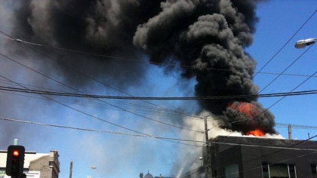 Smoke pours from a blaze which forced the evacuation of a Collingwood business this morning.