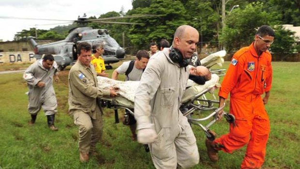 Rescue workers evacuate a survivor of a landslide in Teresopolis, 100 kilometres from Rio de Janeiro.