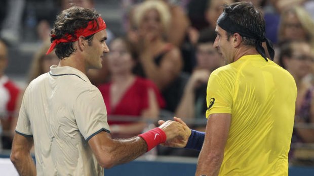 Roger Federer shakes hands with Marinko Matosevic following their one-sided match.