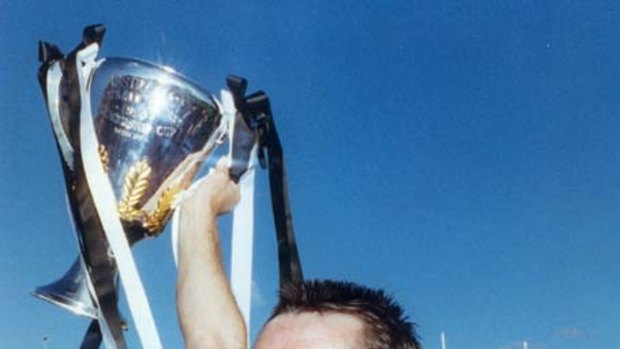 Tony Shaw holds up the Premiership Cup after Collingwood defeated Essendon.